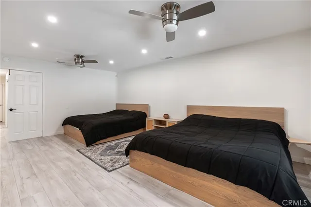a bedroom with bed and a ceiling fan