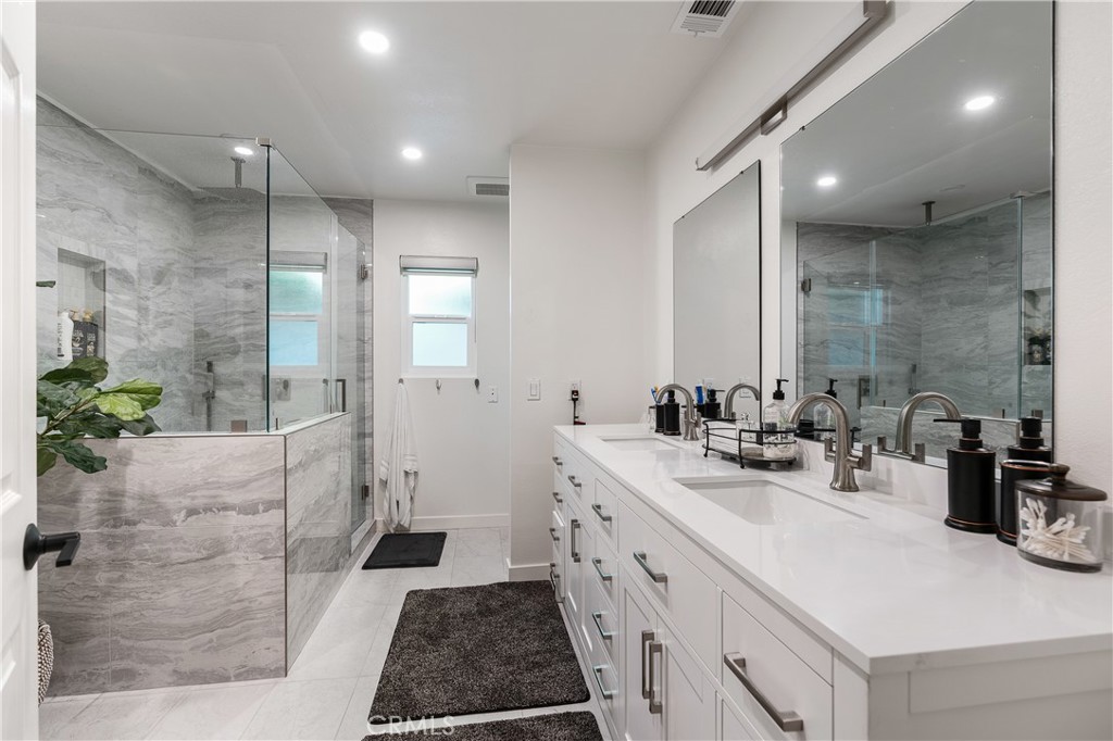 68920 Concepcion Road Cathedral City, CA 92234 - Photo 17 of 35 a bathroom with a double vanity sink a toilet and shower