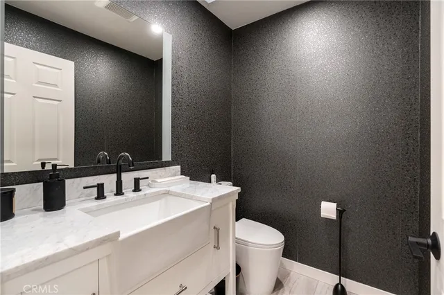 a bathroom with a sink toilet and mirror