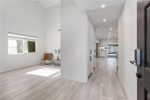 a view of a living room hardwood floor and a kitchen