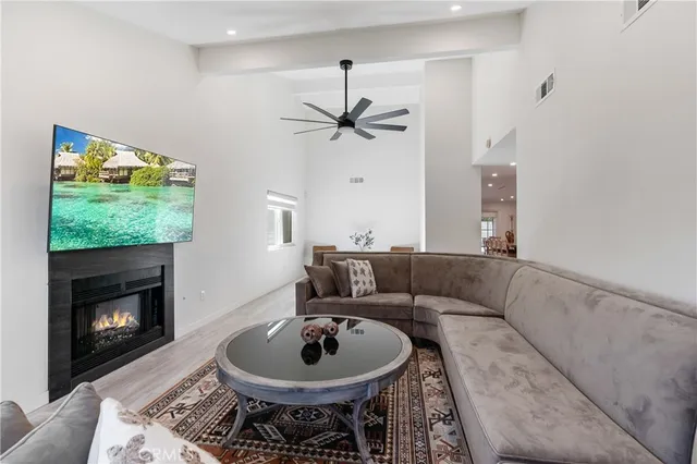 a living room with furniture a fireplace and a flat screen tv