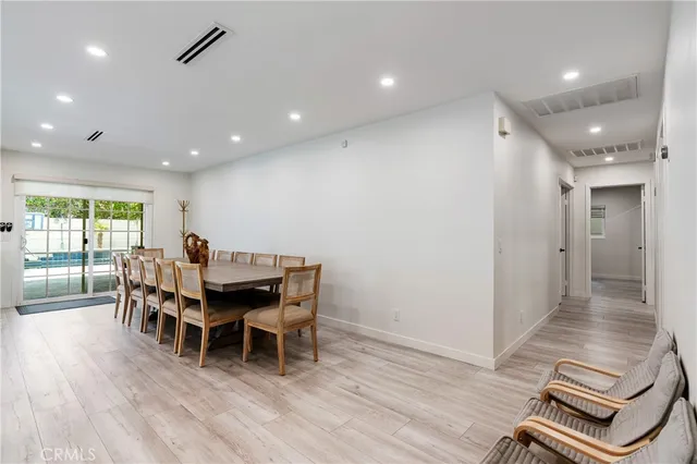 a dining room with furniture and wooden floor