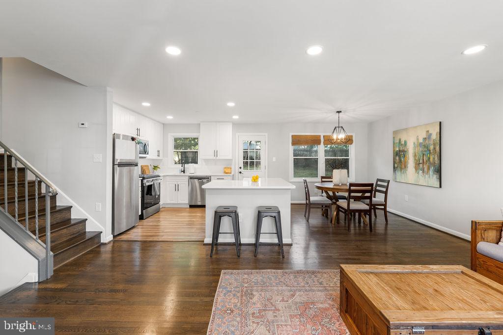 3018 Kramer Street Silver Spring, MD 20902 - Photo 8 of 38 a dining hall with stainless steel appliances granite countertop wooden floor a dining table and chairs