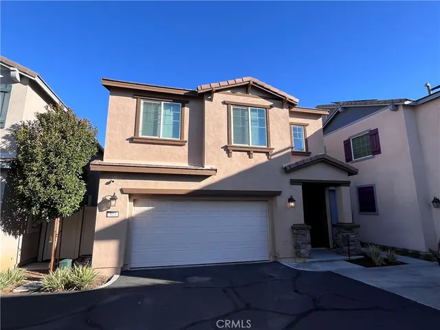 a front view of a house with plants