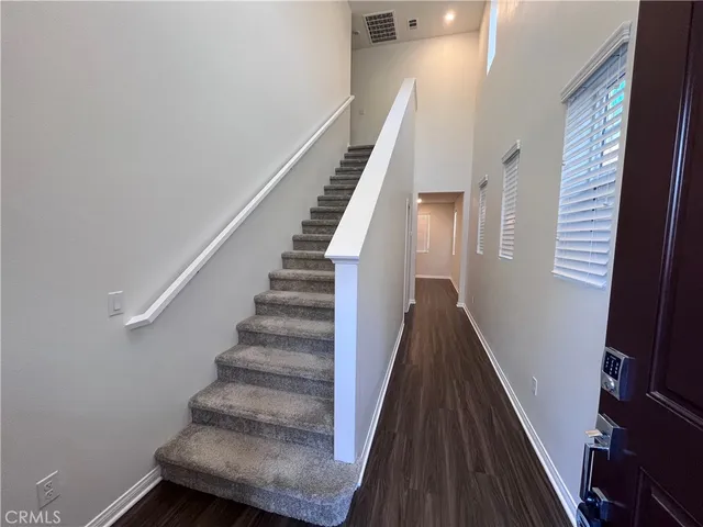 a view of entryway and hall with wooden floor