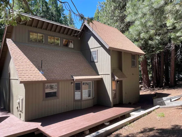 a view of house with backyard