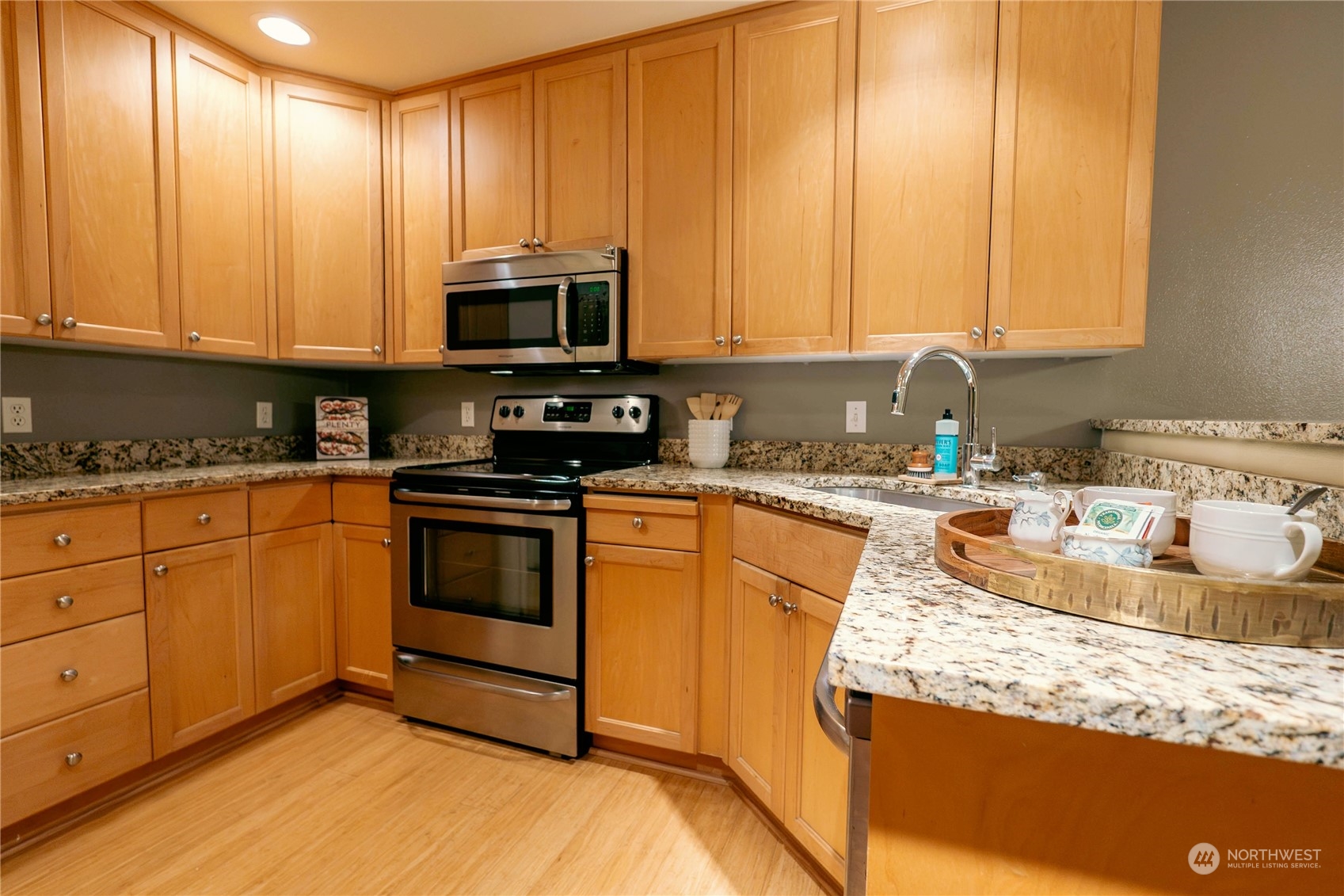 559 Elma Place Northeast Renton, WA 98059 - Photo 11 of 30 a kitchen with stainless steel appliances granite countertop a stove a sink and a microwave
