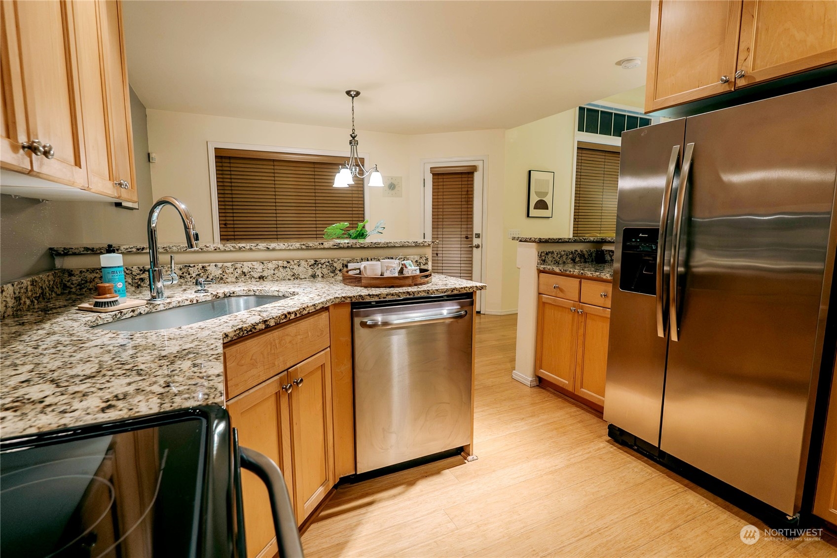 559 Elma Place Northeast Renton, WA 98059 - Photo 12 of 30 a kitchen with stainless steel appliances granite countertop a sink stove and refrigerator