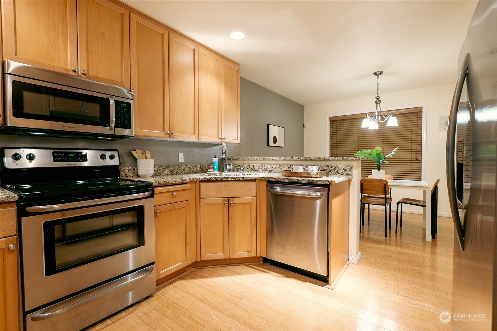 559 Elma Place Northeast Renton, WA 98059 - Photo 13 of 30 a kitchen with stainless steel appliances granite countertop a stove a sink and a microwave