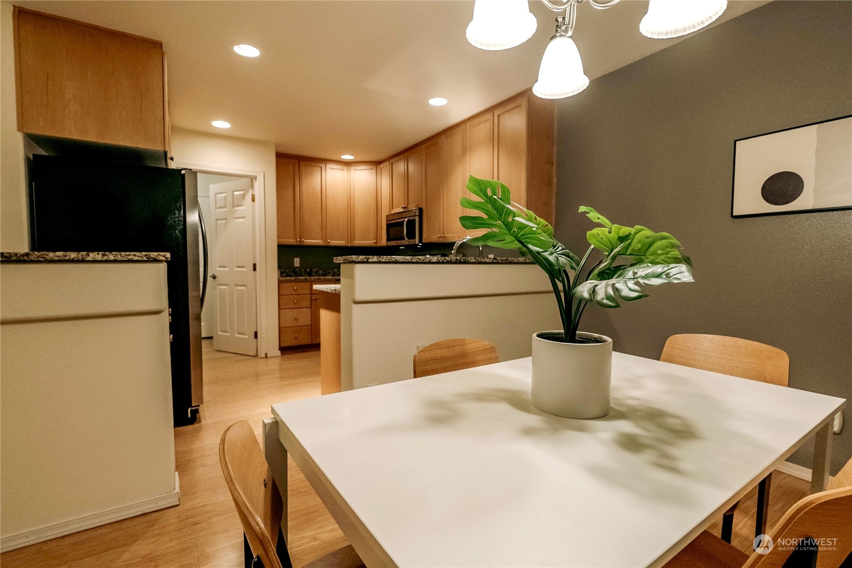 559 Elma Place Northeast Renton, WA 98059 - Photo 10 of 30 a dining room with furniture a potted plant and kitchen view
