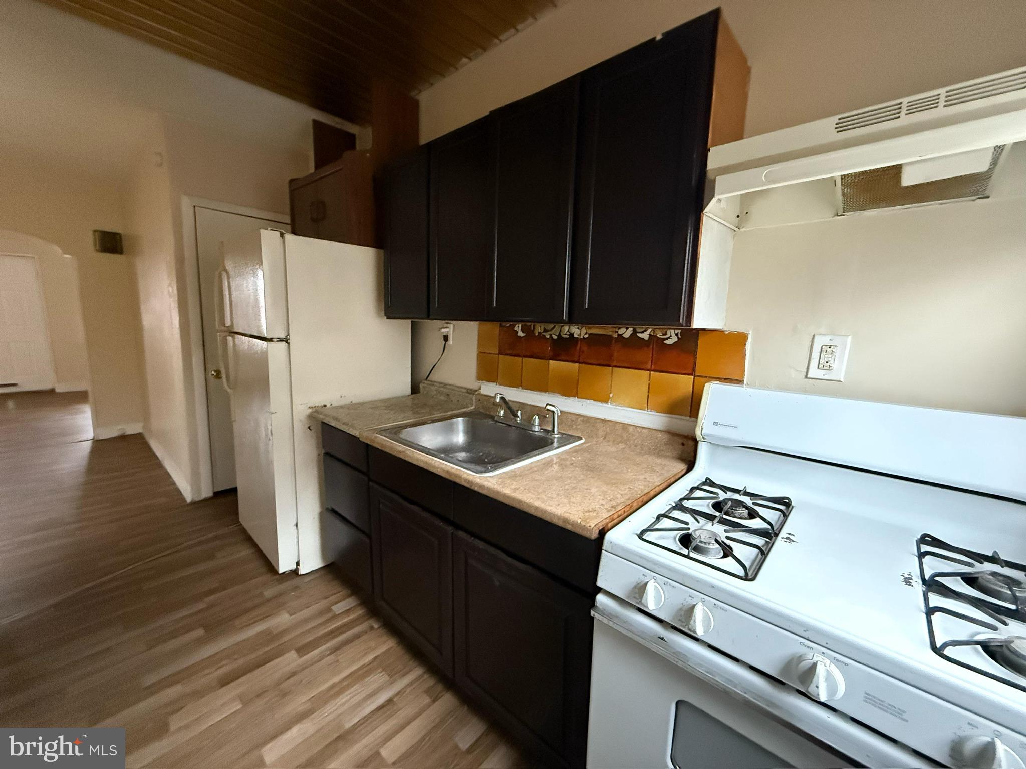 1603 South Dover Street Philadelphia, PA 19145 - Photo 12 of 12 a kitchen with a sink a refrigerator and cabinets
