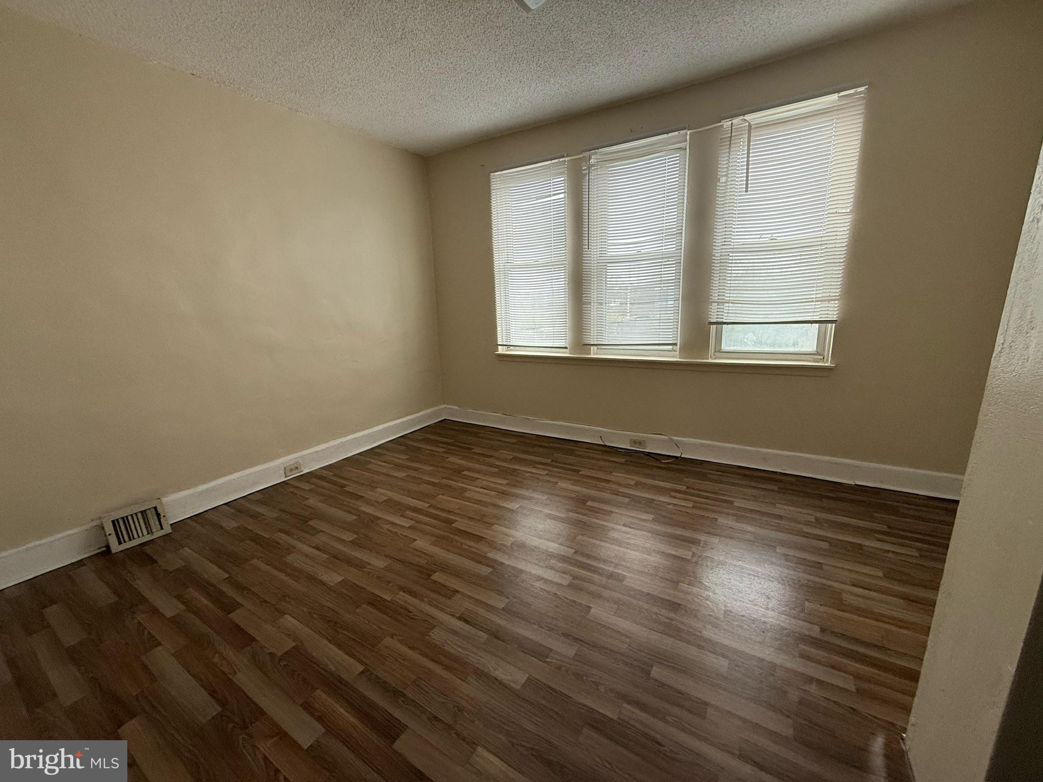 1603 South Dover Street Philadelphia, PA 19145 - Photo 5 of 12 wooden floor in an empty room with a window