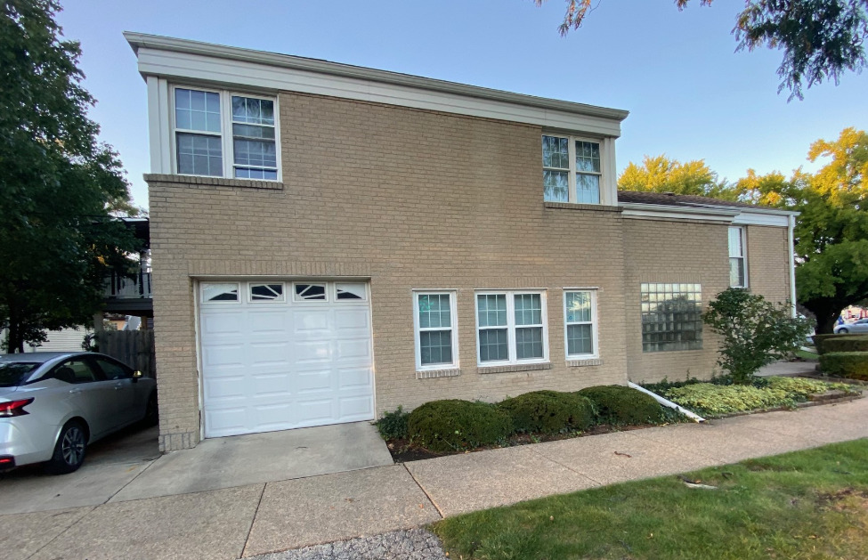 2944 Harlem Avenue, Unit 3 Riverside, IL 60546 - Photo 1 of 15 a front view of a house with a yard