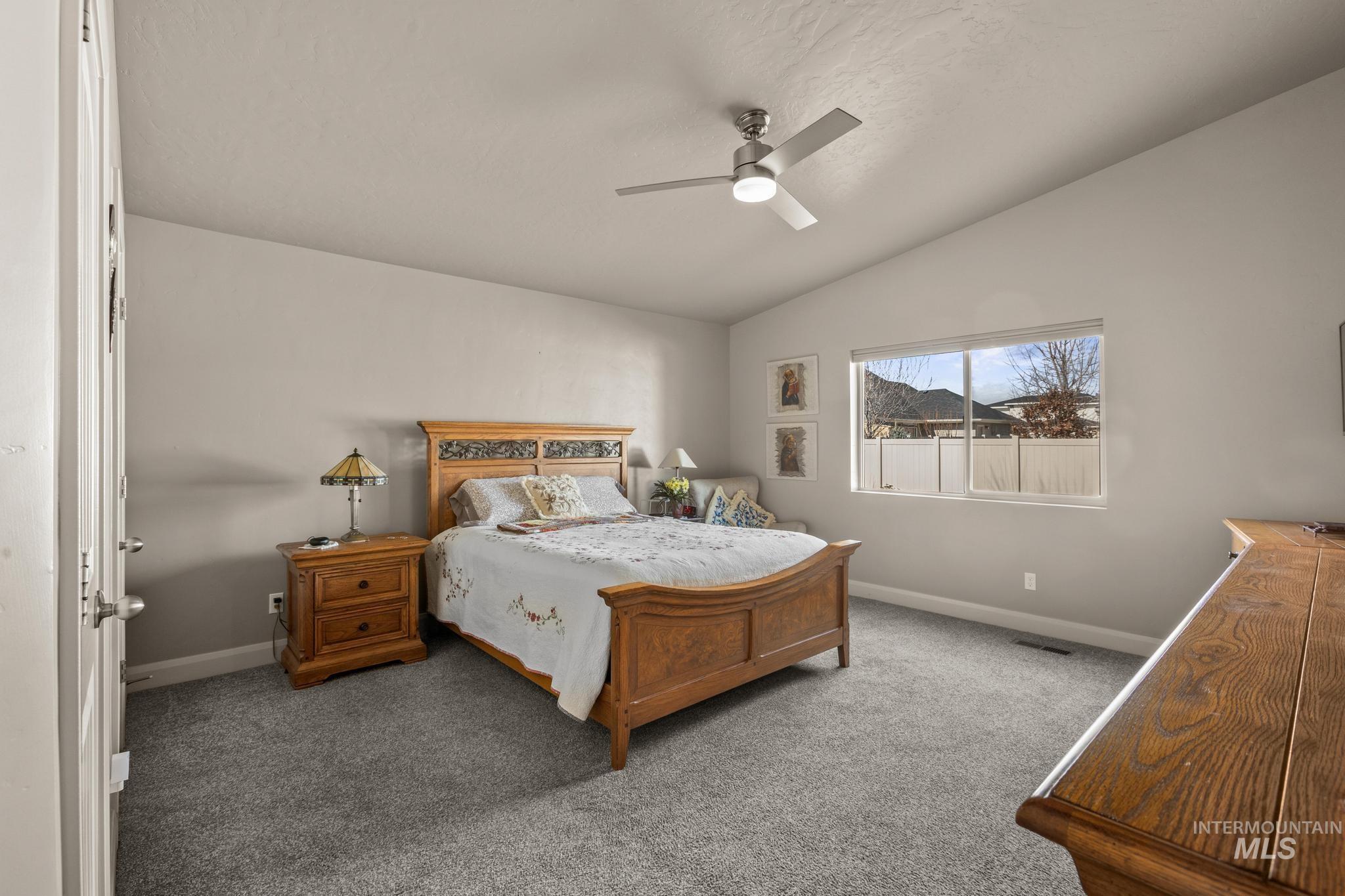 5832 West Rotherham Drive Eagle, ID 83616 - Photo 16 of 42 Bedroom with lofted ceiling, carpet, and ceiling fan