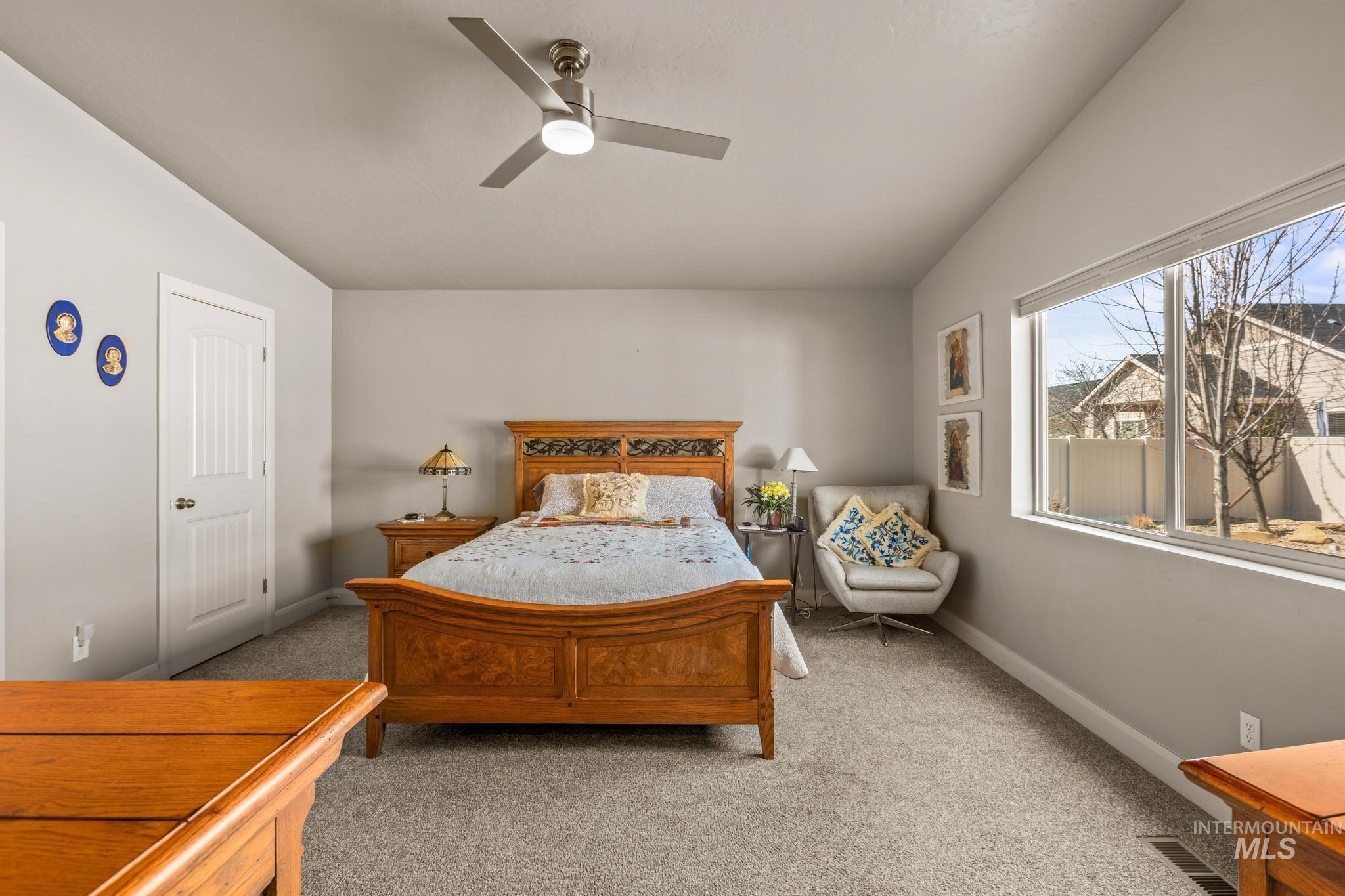 5832 West Rotherham Drive Eagle, ID 83616 - Photo 18 of 42 Bedroom with light colored carpet, a ceiling fan, and lofted ceiling