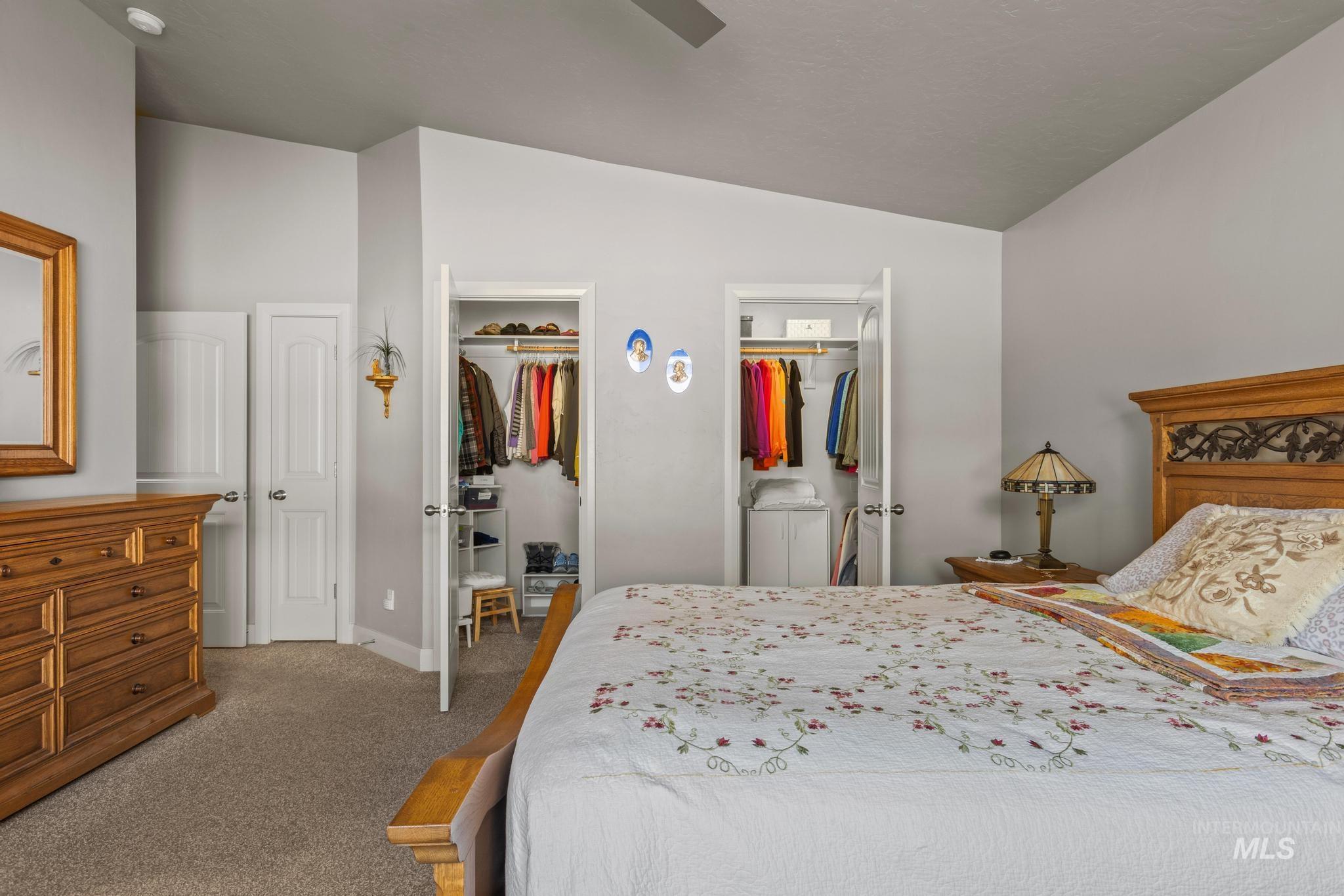 5832 West Rotherham Drive Eagle, ID 83616 - Photo 19 of 42 Bedroom featuring vaulted ceiling, carpet, ceiling fan, and ensuite bathroom