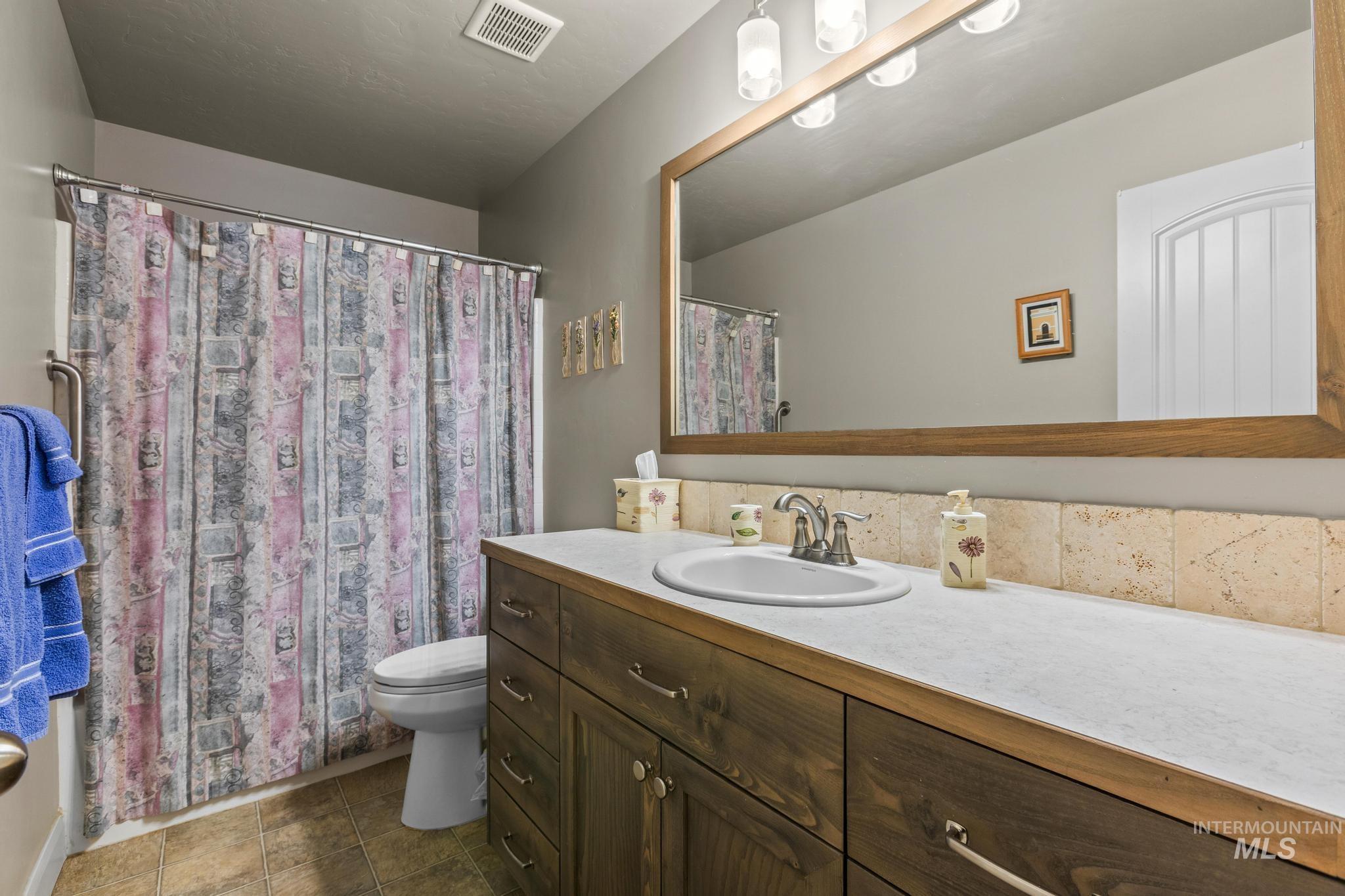 5832 West Rotherham Drive Eagle, ID 83616 - Photo 27 of 42 Bathroom featuring vanity and a shower with shower curtain