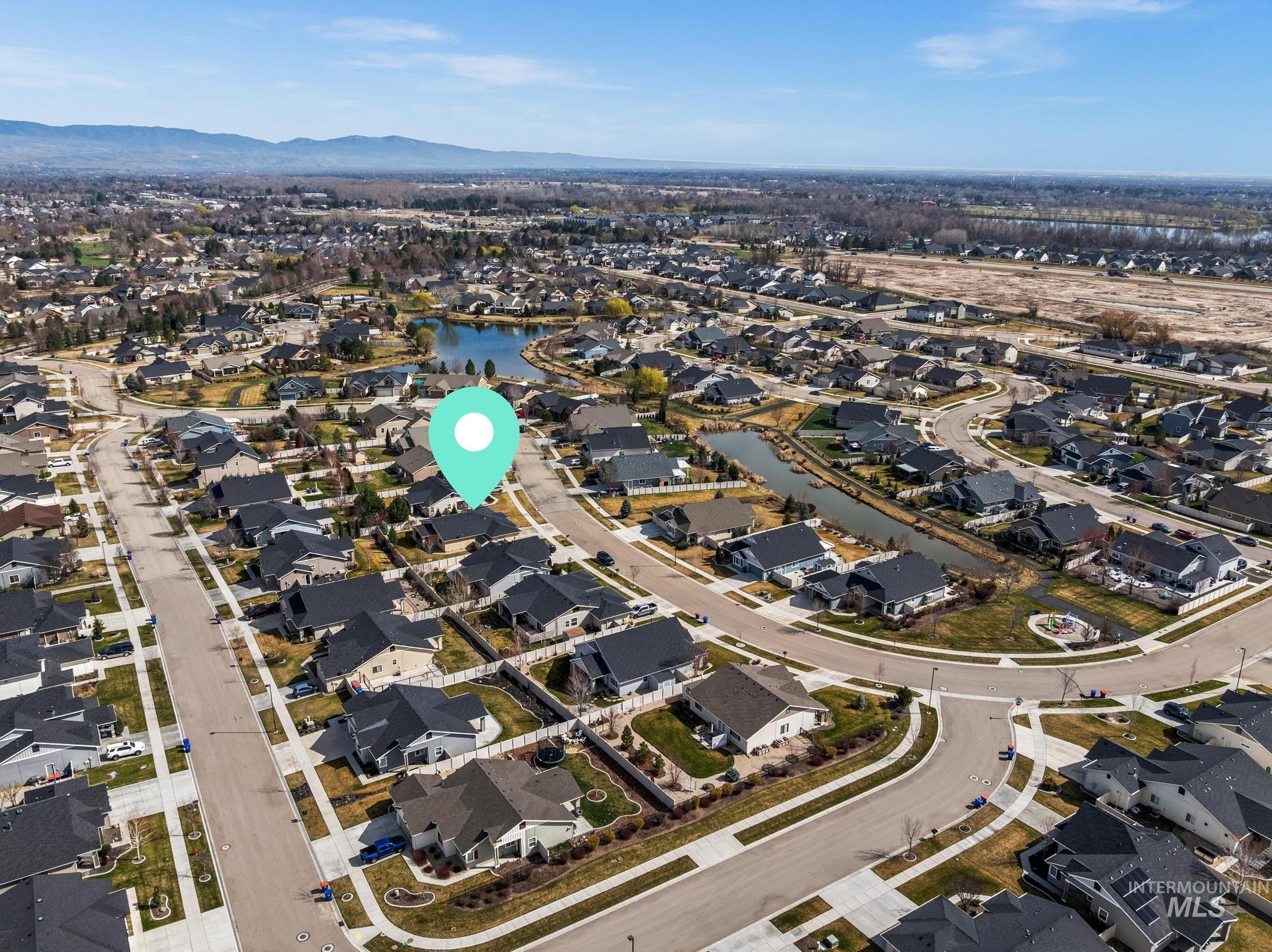 5832 West Rotherham Drive Eagle, ID 83616 - Photo 37 of 42 Aerial overview of property's location with nearby suburban area and a water and mountain view
