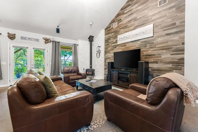a living room with furniture a large window and a flat screen tv