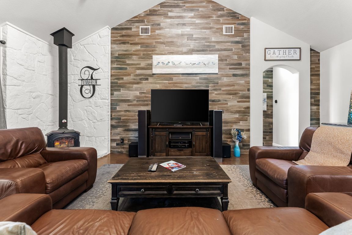 4204 Arthur Circle Leander, TX 78641 - Photo 12 of 40 a living room with furniture a flat screen tv and a fireplace