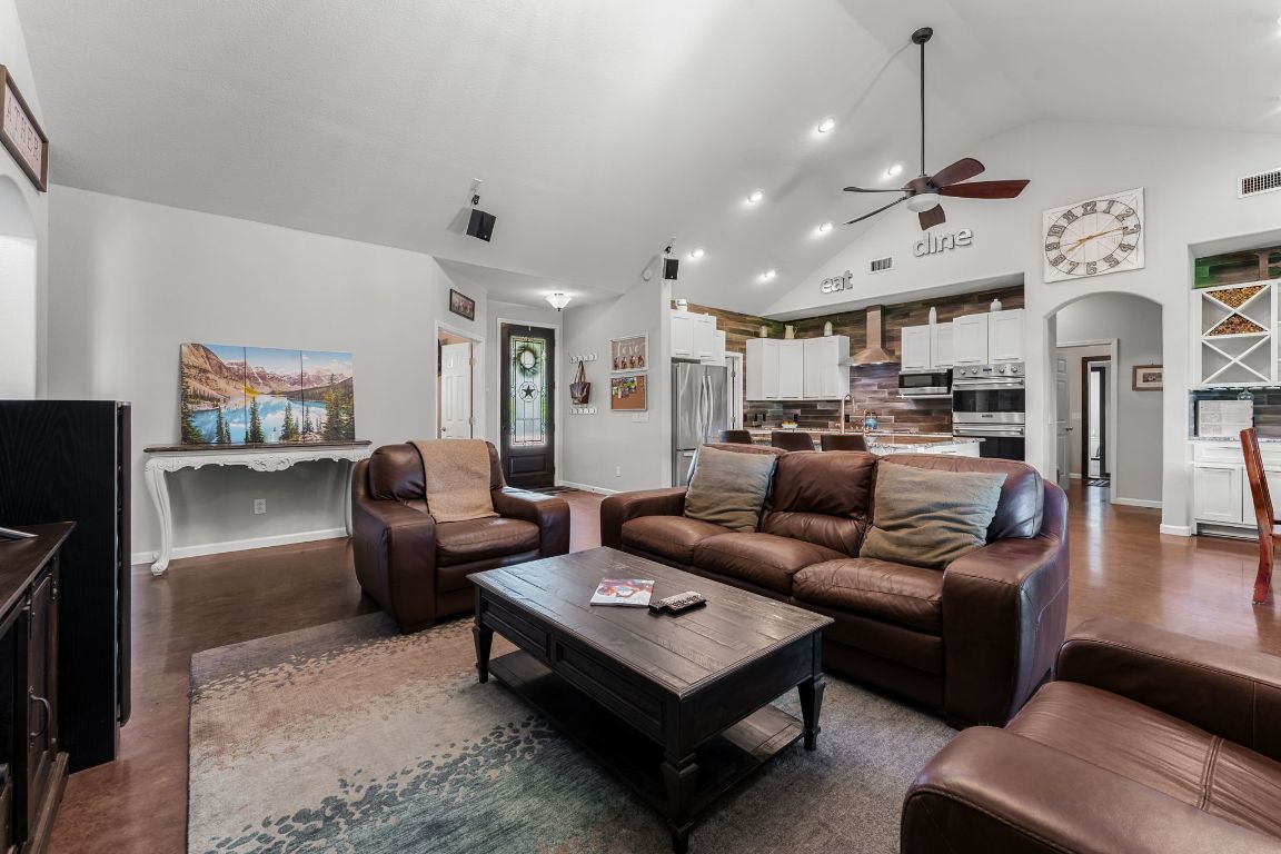 4204 Arthur Circle Leander, TX 78641 - Photo 13 of 40 a living room with furniture kitchen view and a chandelier
