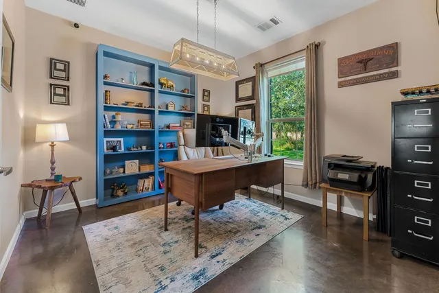 a living room with furniture and a bookshelf