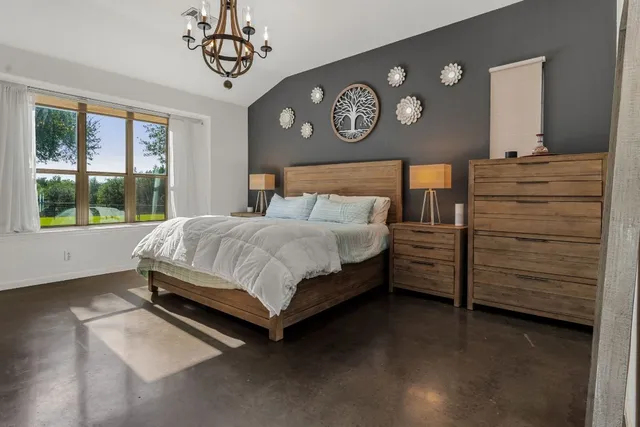 a bedroom with a bed and a window