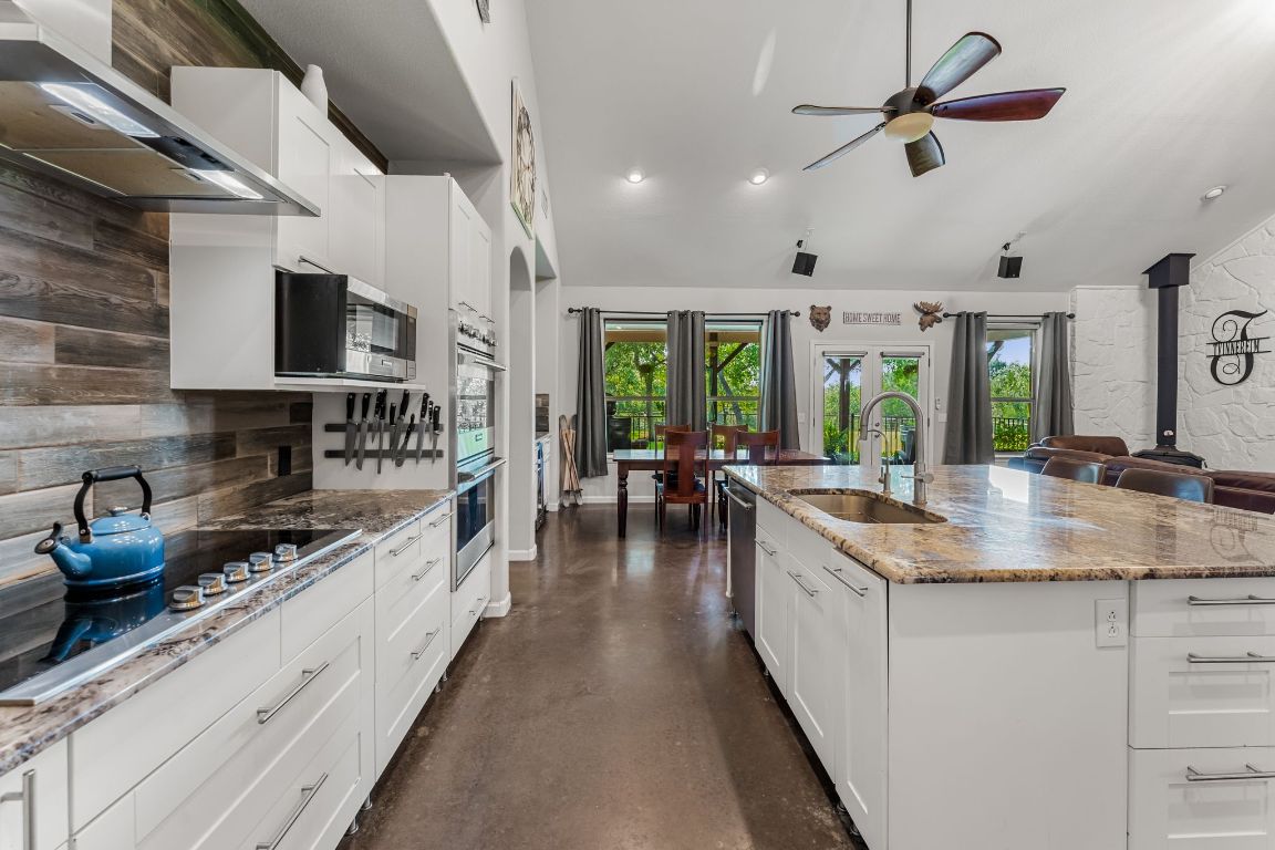 4204 Arthur Circle Leander, TX 78641 - Photo 2 of 40 a kitchen with stainless steel appliances granite countertop a sink a stove and a wooden floors