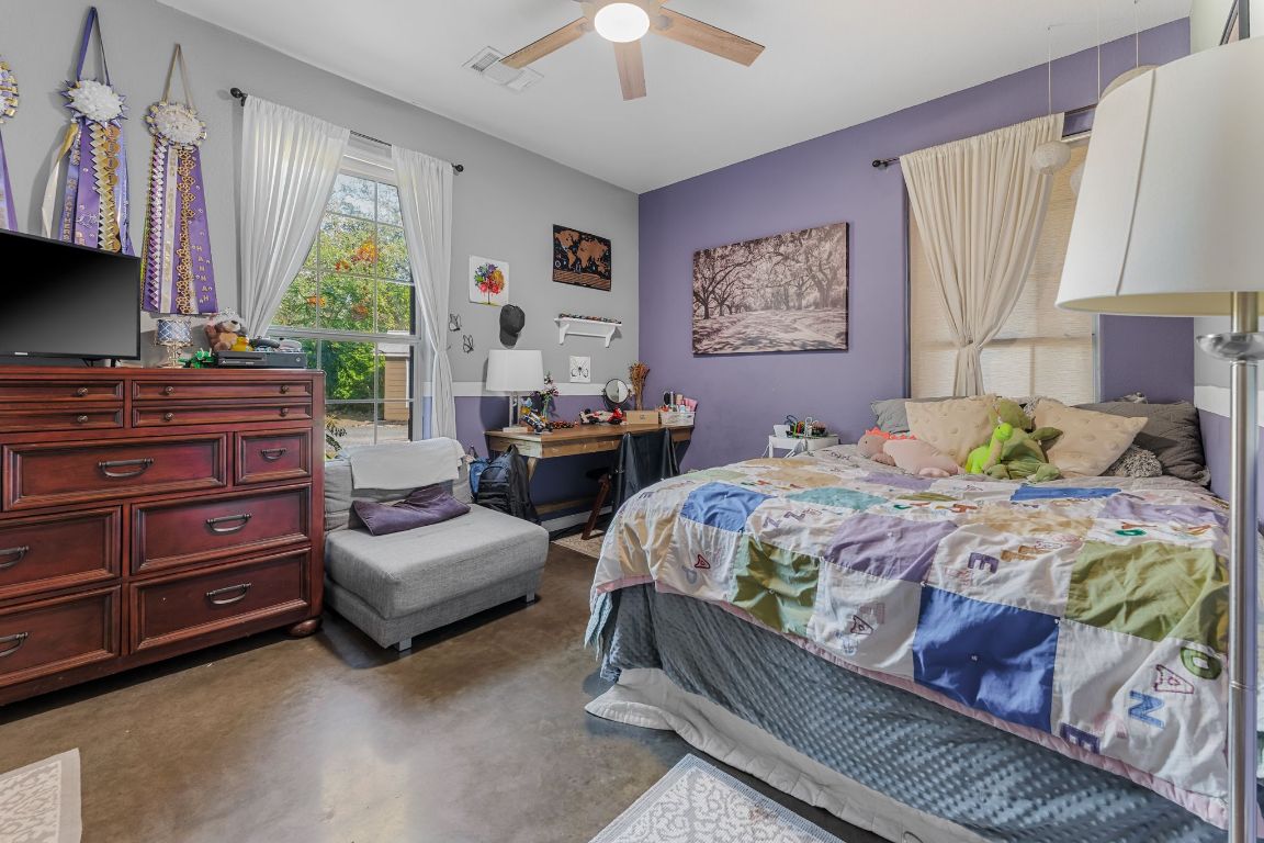 4204 Arthur Circle Leander, TX 78641 - Photo 23 of 40 a bedroom with a bed and a chandelier