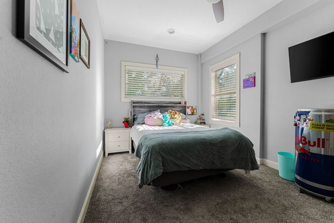 4204 Arthur Circle Leander, TX 78641 - Photo 27 of 40 a bedroom with a bed a flat screen tv and windows