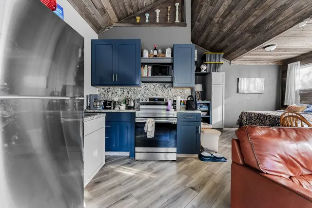 a kitchen with stainless steel appliances granite countertop a stove and a refrigerator