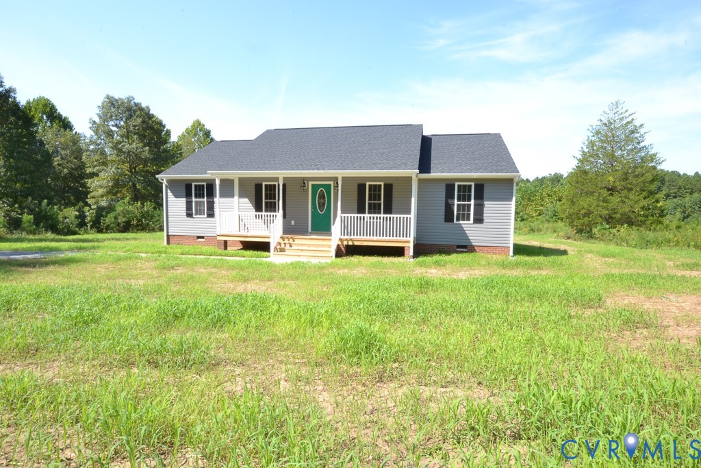 a view of a house with a yard and sitting area