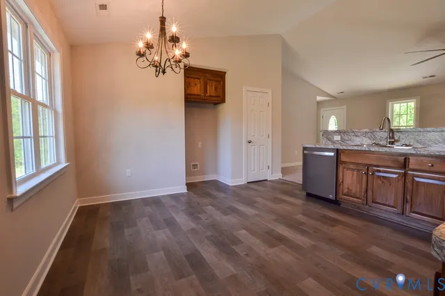 a view of a kitchen with kitchen island wooden floor center island and windows