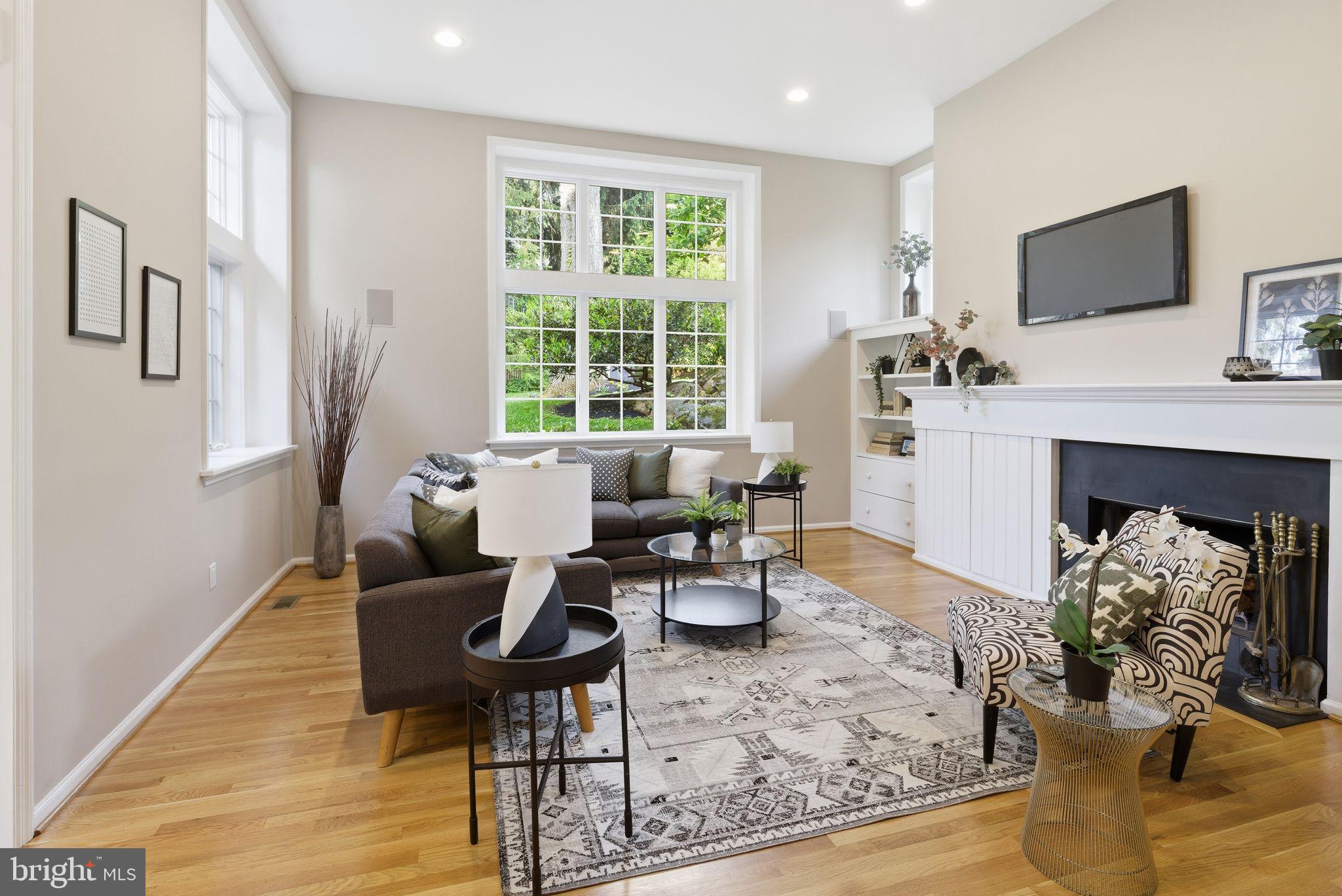 5 Brookside Circle Wayne, PA 19087 - Photo 2 of 49 a living room with furniture a fireplace and a flat screen tv