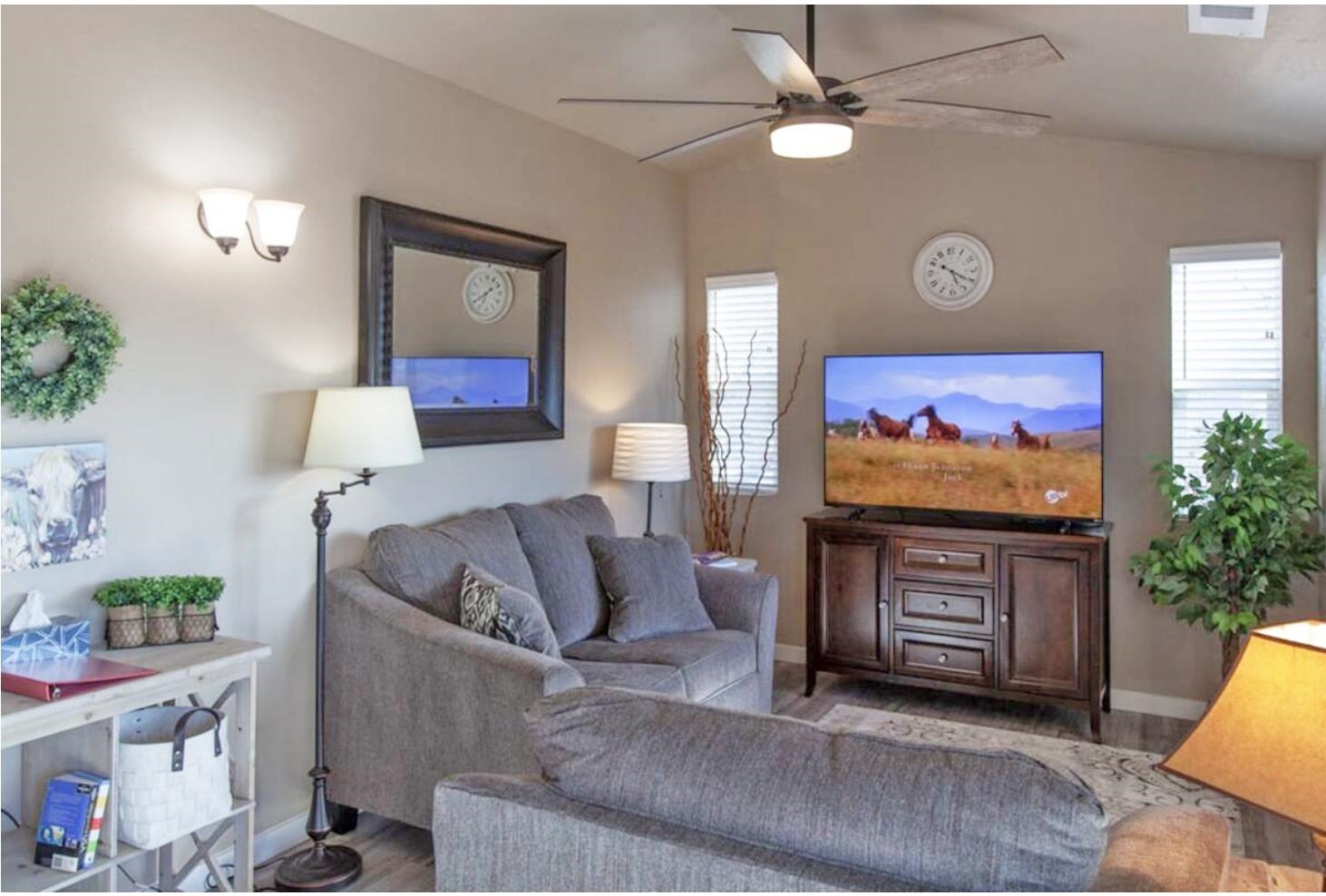 1460 Main Street Grand Junction, CO 81501 - Photo 17 of 31 a living room with furniture and a flat screen tv