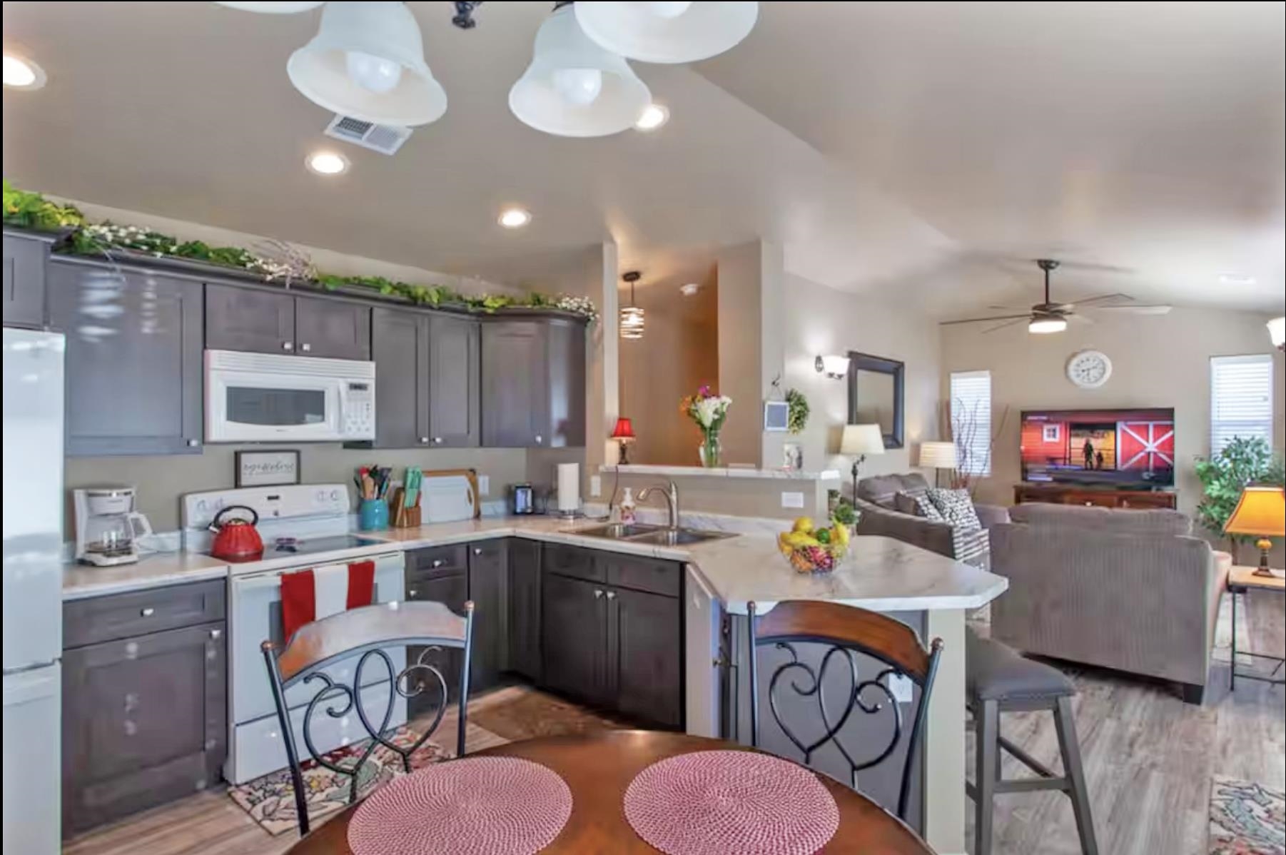 1460 Main Street Grand Junction, CO 81501 - Photo 18 of 31 a kitchen with a dining table chairs sink and microwave