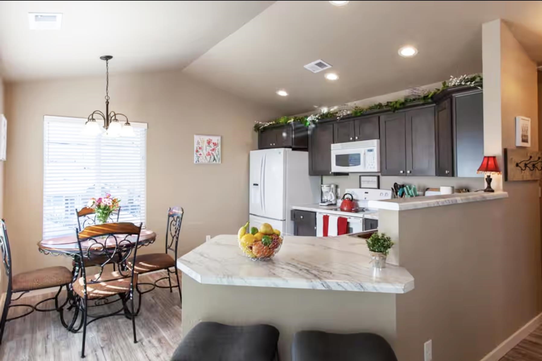 1460 Main Street Grand Junction, CO 81501 - Photo 19 of 31 a kitchen with a dining table chairs refrigerator and sink