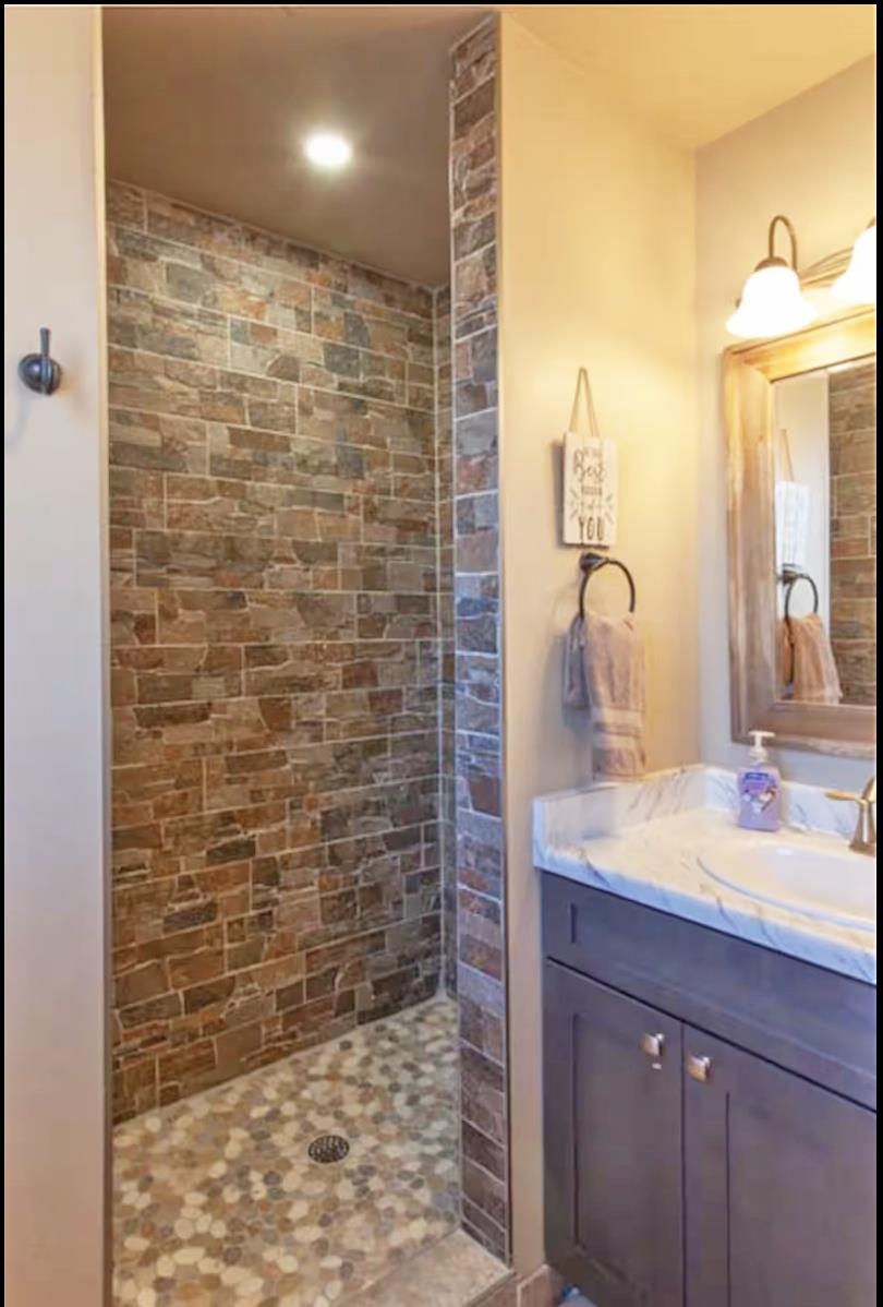 1460 Main Street Grand Junction, CO 81501 - Photo 21 of 31 a bathroom with a sink and a mirror