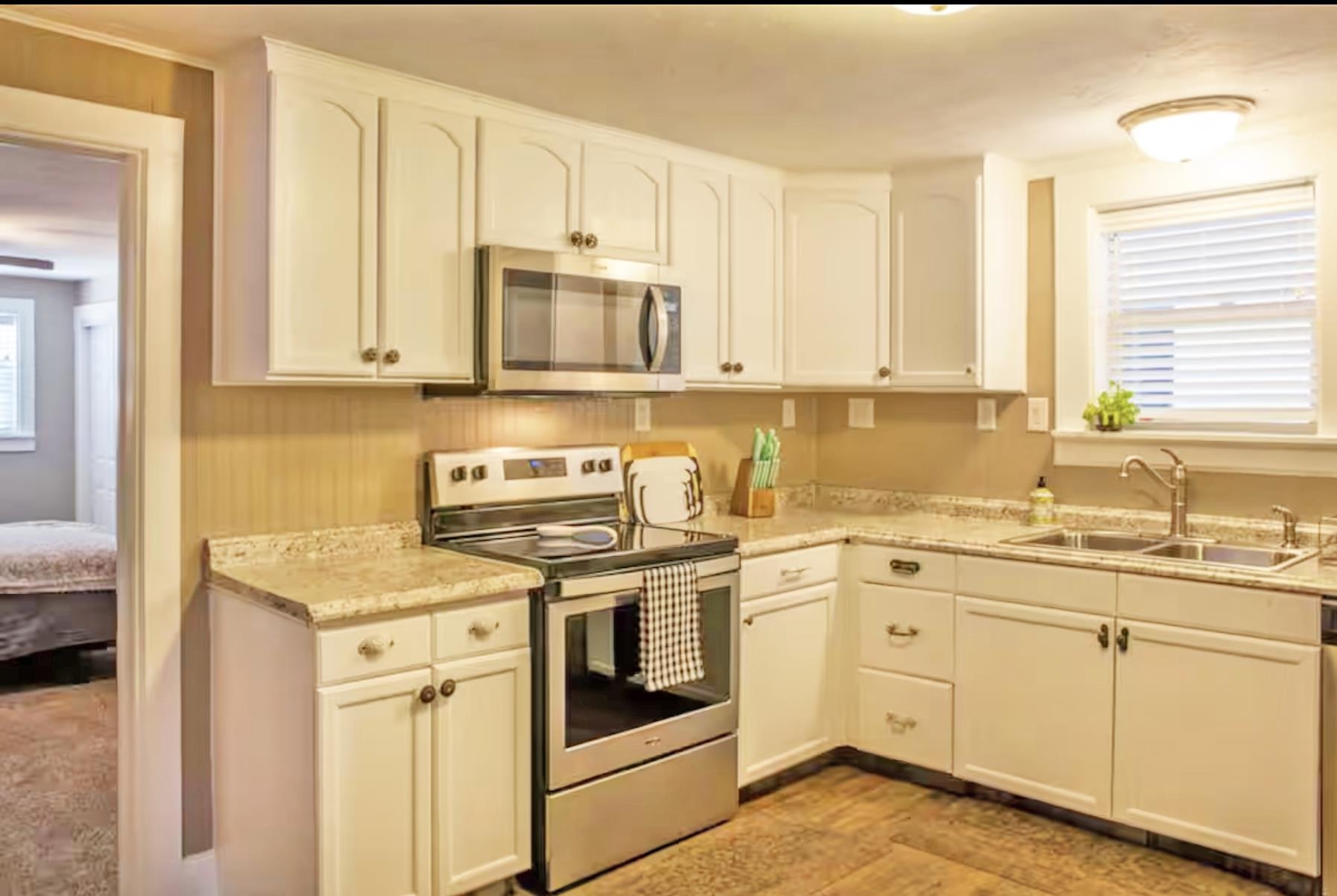 1460 Main Street Grand Junction, CO 81501 - Photo 8 of 31 a kitchen with stainless steel appliances granite countertop a sink stove and cabinets