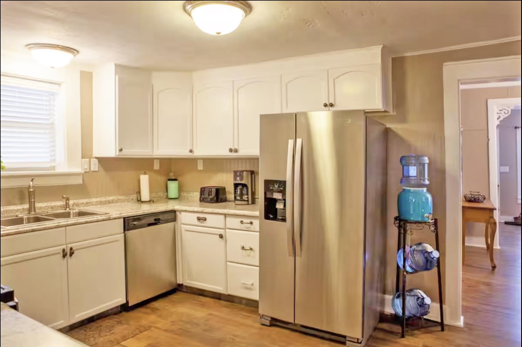 1460 Main Street Grand Junction, CO 81501 - Photo 9 of 31 a kitchen with stainless steel appliances a refrigerator sink and cabinets