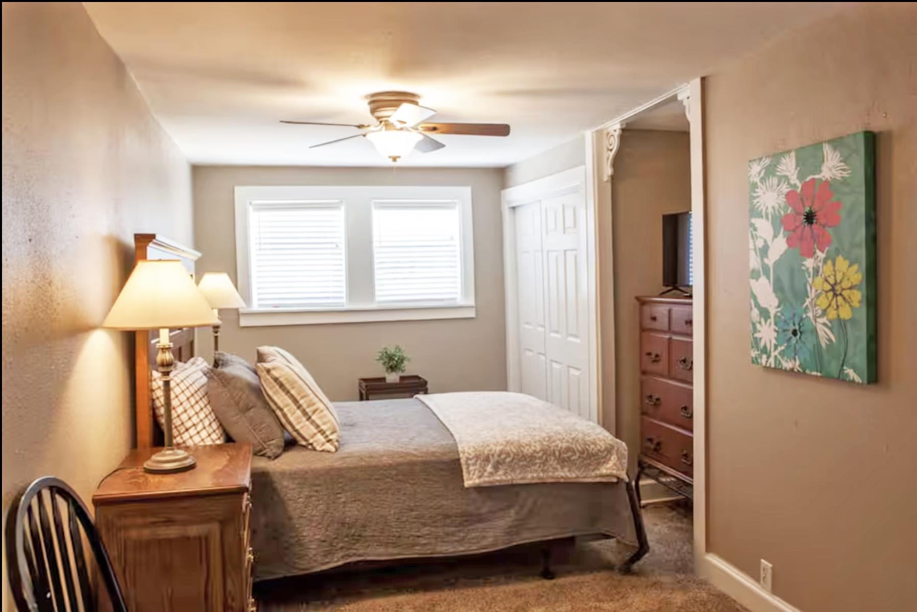1460 Main Street Grand Junction, CO 81501 - Photo 10 of 31 a bedroom with a bed and a chandelier
