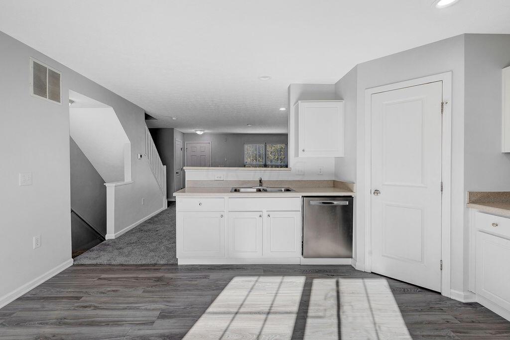 6345 Needletail Road, Unit 24634 Columbus, OH 43230 - Photo 10 of 58 • New luxury vinyl plank flooring ~ 2021 • Gray painted walls • Bevelled edge countertops • White, raised panel cabinets • Double bowl, stainless steel sink • New Frigidaire® dishwasher ~ 2021 • New Frigidaire® electric range ~ 2021 • New Frigidaire® microwave ~ 2021 • New Frigidaire® refrigerator ~ 2021 • Step-in pantry closet • Can lighting • Insinkerator® disposal • New double sliding doors (2020) to privacy fenced, paver patio
