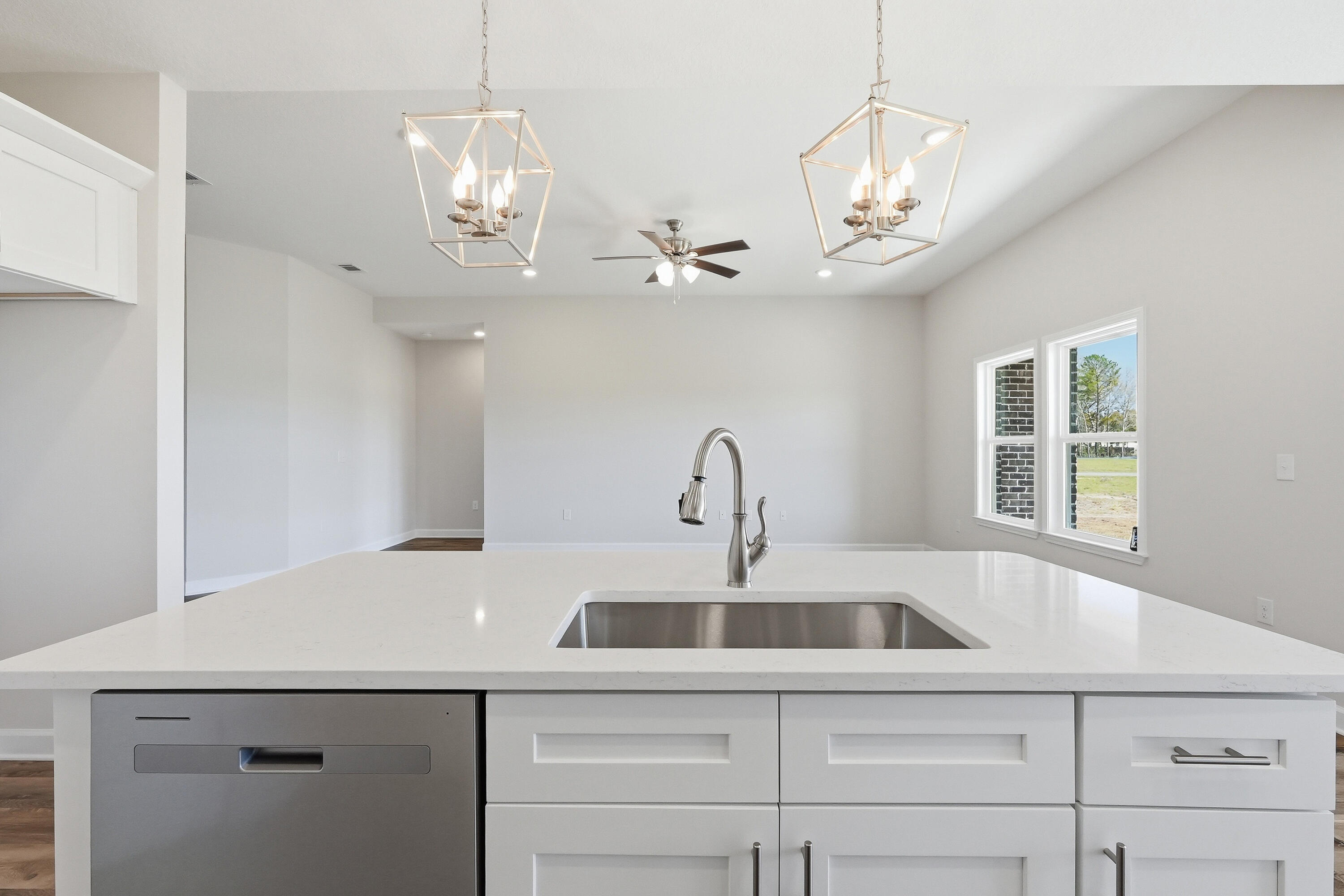 6114 Mildreds Way Crestview, FL 32539 - Photo 11 of 24 a kitchen with a sink a chandelier stainless steel appliances cabinets and a chandelier