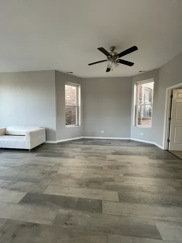 a view of empty room with ceiling fan