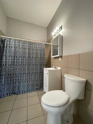 a bathroom with a toilet and a shower