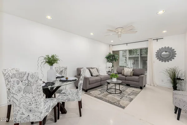 a living room with furniture wooden floor and a chandelier