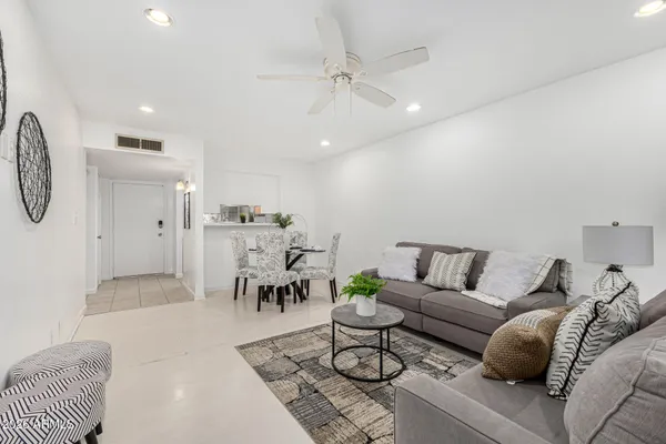 a living room with furniture and a chandelier