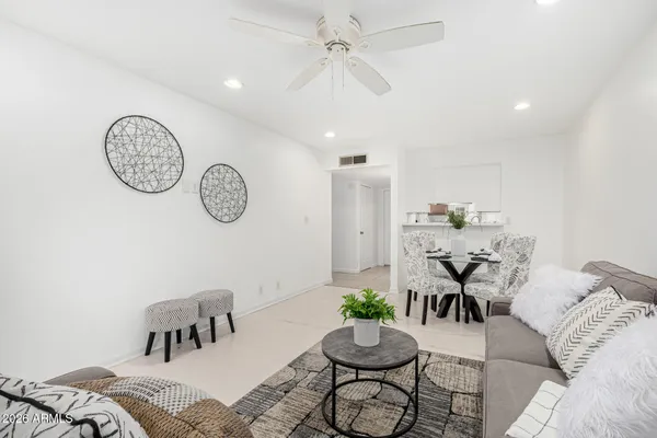 a living room with furniture and a clock