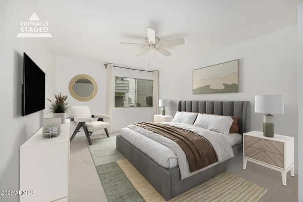 an empty room with windows and fan