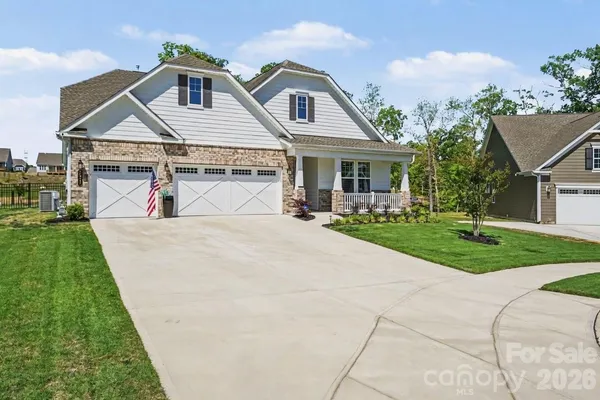 a view of house with yard street and sign board